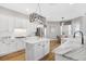 Open concept kitchen with center island, marble countertops, modern appliances, and a dining area off to the side at 5225 Brighton Shore Dr, Apollo Beach, FL 33572