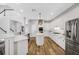 Well-lit kitchen with white cabinets, a center island, and modern appliances, next to stairs and other parts of the house at 5225 Brighton Shore Dr, Apollo Beach, FL 33572