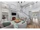 Bright living room with fireplace, built-in shelving, vaulted ceilings, and a graceful staircase at 5225 Brighton Shore Dr, Apollo Beach, FL 33572