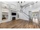Spacious living room with fireplace, hardwood floors, and a grand staircase at 5225 Brighton Shore Dr, Apollo Beach, FL 33572