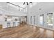 Spacious living area with an open layout, showcasing hardwood floors, a breakfast bar, and seamless access to the kitchen at 5225 Brighton Shore Dr, Apollo Beach, FL 33572