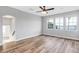 Bright living room with hardwood floors and three windows with a water view at 5225 Brighton Shore Dr, Apollo Beach, FL 33572