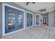 Outdoor patio area featuring blue framed windows and doors that lead to the pool at 5225 Brighton Shore Dr, Apollo Beach, FL 33572