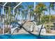 Captivating pool featuring rock waterfall, screened enclosure and tropical palms at 5225 Brighton Shore Dr, Apollo Beach, FL 33572