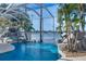 Gorgeous blue pool features a rocky waterfall and tropical landscaping with tranquil water views at 5225 Brighton Shore Dr, Apollo Beach, FL 33572