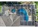 Aerial view of a screened in pool with rock features and palm trees beside the home at 5225 Brighton Shore Dr, Apollo Beach, FL 33572