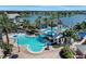 Aerial view of a resort-style pool featuring a lighthouse, slides, palm trees, and relaxing lounge chairs by the water at 5225 Brighton Shore Dr, Apollo Beach, FL 33572