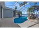 View of pool and bay with rock waterfall and lush tropical plants at 5225 Brighton Shore Dr, Apollo Beach, FL 33572