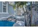 Stone waterfall feature flowing into a pool, surrounded by palm trees at 5225 Brighton Shore Dr, Apollo Beach, FL 33572