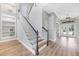 Bright entryway featuring a staircase with black handrails and wood floors at 5225 Brighton Shore Dr, Apollo Beach, FL 33572