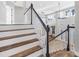 Staircase with wood treads and white risers leading to an open space with views of the living and dining area at 5225 Brighton Shore Dr, Apollo Beach, FL 33572
