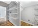 A walk-in closet with extensive white wire shelving and wood-look floors at 5225 Brighton Shore Dr, Apollo Beach, FL 33572