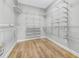 Walk-in closet with metal shelving and wood flooring at 5225 Brighton Shore Dr, Apollo Beach, FL 33572