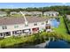 A well maintained home overlooking a serene pond with a fountain and outdoor seating at 5496 Riverwalk Preserve Dr, New Port Richey, FL 34653