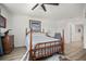 Charming bedroom with wood-look floors, ceiling fan, and natural light at 5496 Riverwalk Preserve Dr, New Port Richey, FL 34653