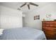 Spacious bedroom featuring a ceiling fan, dresser, and closet at 5496 Riverwalk Preserve Dr, New Port Richey, FL 34653