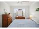 Inviting bedroom with wood-look floors, ceiling fan, and natural light at 5496 Riverwalk Preserve Dr, New Port Richey, FL 34653