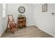 Bonus room featuring hardwood floors, a vintage desk, and a ladder at 5496 Riverwalk Preserve Dr, New Port Richey, FL 34653