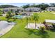 Community clubhouse and pool area with lounge seating and manicured lawns at 5496 Riverwalk Preserve Dr, New Port Richey, FL 34653