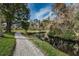 Creek with scenic landscaping and a relaxing walking path for all residents to enjoy at 5496 Riverwalk Preserve Dr, New Port Richey, FL 34653