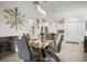 Bright dining room featuring a modern table, stylish chairs, and elegant pendant lighting at 5496 Riverwalk Preserve Dr, New Port Richey, FL 34653