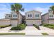 Charming townhomes with a brick-paved drive, garages, and well manicured tropical landscaping at 5496 Riverwalk Preserve Dr, New Port Richey, FL 34653