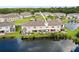 Charming exterior with patio seating areas, enhanced by a scenic waterfront view of the pond at 5496 Riverwalk Preserve Dr, New Port Richey, FL 34653