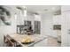 Modern kitchen with island, granite countertops, stainless steel appliances, and white cabinetry at 5496 Riverwalk Preserve Dr, New Port Richey, FL 34653