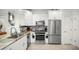 Clean, well-lit kitchen featuring stainless steel appliances, white cabinets and granite countertops at 5496 Riverwalk Preserve Dr, New Port Richey, FL 34653