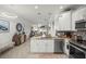 Open concept kitchen with stainless steel appliances and granite countertops and open to the living area at 5496 Riverwalk Preserve Dr, New Port Richey, FL 34653