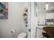 Convenient powder room featuring a toilet, small sink, and storage accessories at 5496 Riverwalk Preserve Dr, New Port Richey, FL 34653