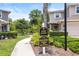 Street view of the community entrance featuring lush landscaping and private access for residents and guests at 5496 Riverwalk Preserve Dr, New Port Richey, FL 34653