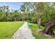 Residents' private walking path with mature trees, lush landscaping, and a tranquil setting at 5496 Riverwalk Preserve Dr, New Port Richey, FL 34653