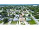 Neighborhood aerial shot showing a well-situated home with a private pool amidst lush greenery at 5672 62Nd N Way, St Petersburg, FL 33709