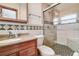Updated bathroom with tiled shower, glass door, and neutral colors at 5672 62Nd N Way, St Petersburg, FL 33709