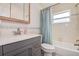 Updated bathroom boasts a modern vanity, tub with shower, and ample natural light at 5672 62Nd N Way, St Petersburg, FL 33709