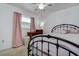 Cozy bedroom featuring a metal bed frame, window, and charming pink curtains at 5672 62Nd N Way, St Petersburg, FL 33709