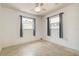 Bright bedroom featuring a ceiling fan and natural light from two windows at 5672 62Nd N Way, St Petersburg, FL 33709