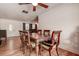 Well-lit dining room with a ceiling fan, wood floors, and entry to the living room at 5672 62Nd N Way, St Petersburg, FL 33709