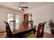Cozy dining room with wood table, ceiling fan, and sliding glass doors to the pool at 5672 62Nd N Way, St Petersburg, FL 33709