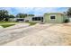 View of a charming home with curved driveway and landscaping at 5672 62Nd N Way, St Petersburg, FL 33709