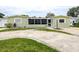 Charming home exterior with circular driveway and lawn at 5672 62Nd N Way, St Petersburg, FL 33709