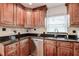 The kitchen features stainless steel appliances, granite countertops, and wood cabinets at 5672 62Nd N Way, St Petersburg, FL 33709