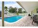 Relaxing pool area with covered patio and seating at 5672 62Nd N Way, St Petersburg, FL 33709