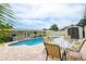 Backyard featuring a pool with table and shed at 5672 62Nd N Way, St Petersburg, FL 33709