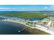 Breathtaking aerial view of waterfront condo complex with a pier, beach, and lush greenery at 611 Destiny Dr # 204, Ruskin, FL 33570