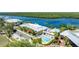 Top-down view of a condo complex featuring a swimming pool, parking, and waterfront access at 611 Destiny Dr # 204, Ruskin, FL 33570
