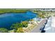 An aerial view shows the community pool and shuffleboard courts next to waterfront at 611 Destiny Dr # 204, Ruskin, FL 33570