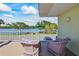 A cozy balcony has comfortable chairs and a view of the water at 611 Destiny Dr # 204, Ruskin, FL 33570
