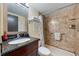 Bathroom featuring granite countertop, updated fixtures, and a well-maintained shower with storage at 611 Destiny Dr # 204, Ruskin, FL 33570